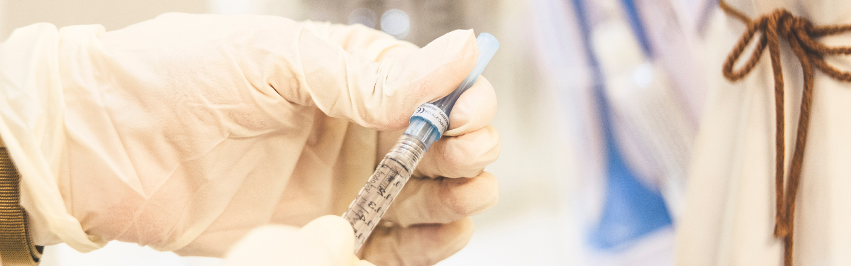 Vaccine needle going into arm