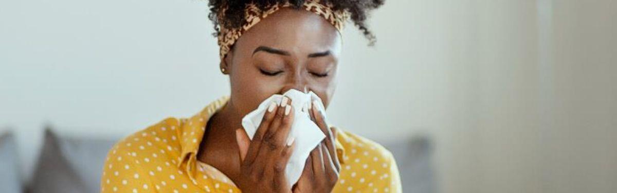 Image of woman blowing her nose