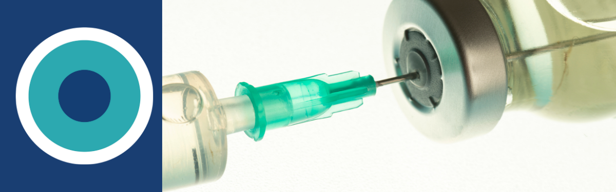 A needle drawing a vaccine from a vial.